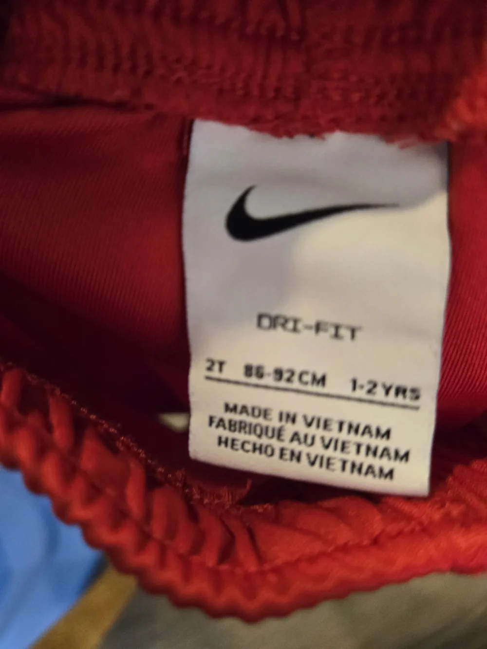 Nike Red Kids Athletic Shorts with Blue Swoosh Accent